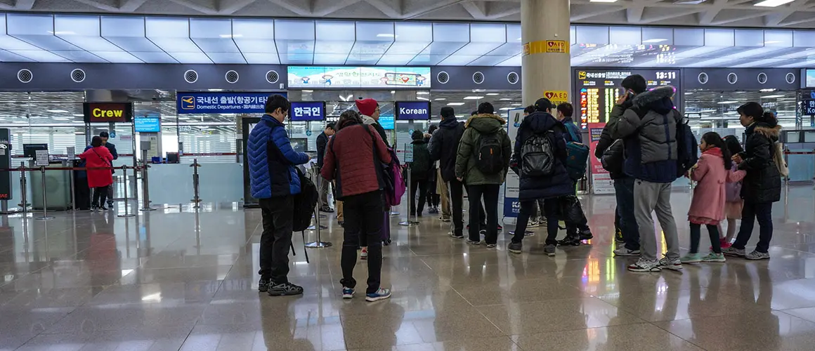 Jeju International Airport domestic departures area with passengers queuing